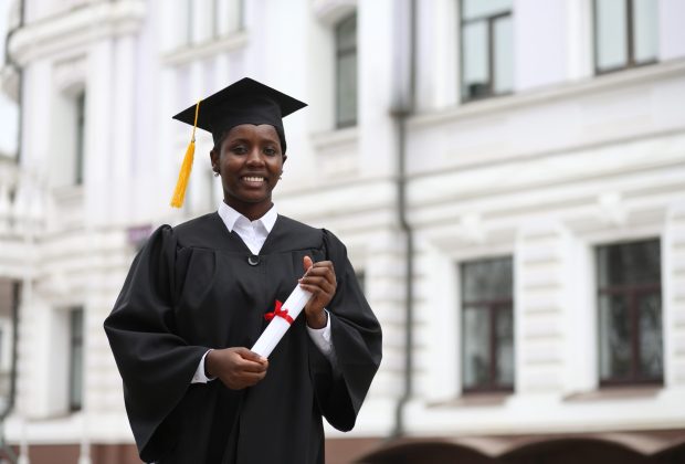 cheerful african american graduate student with diploma in her hand. High quality photo